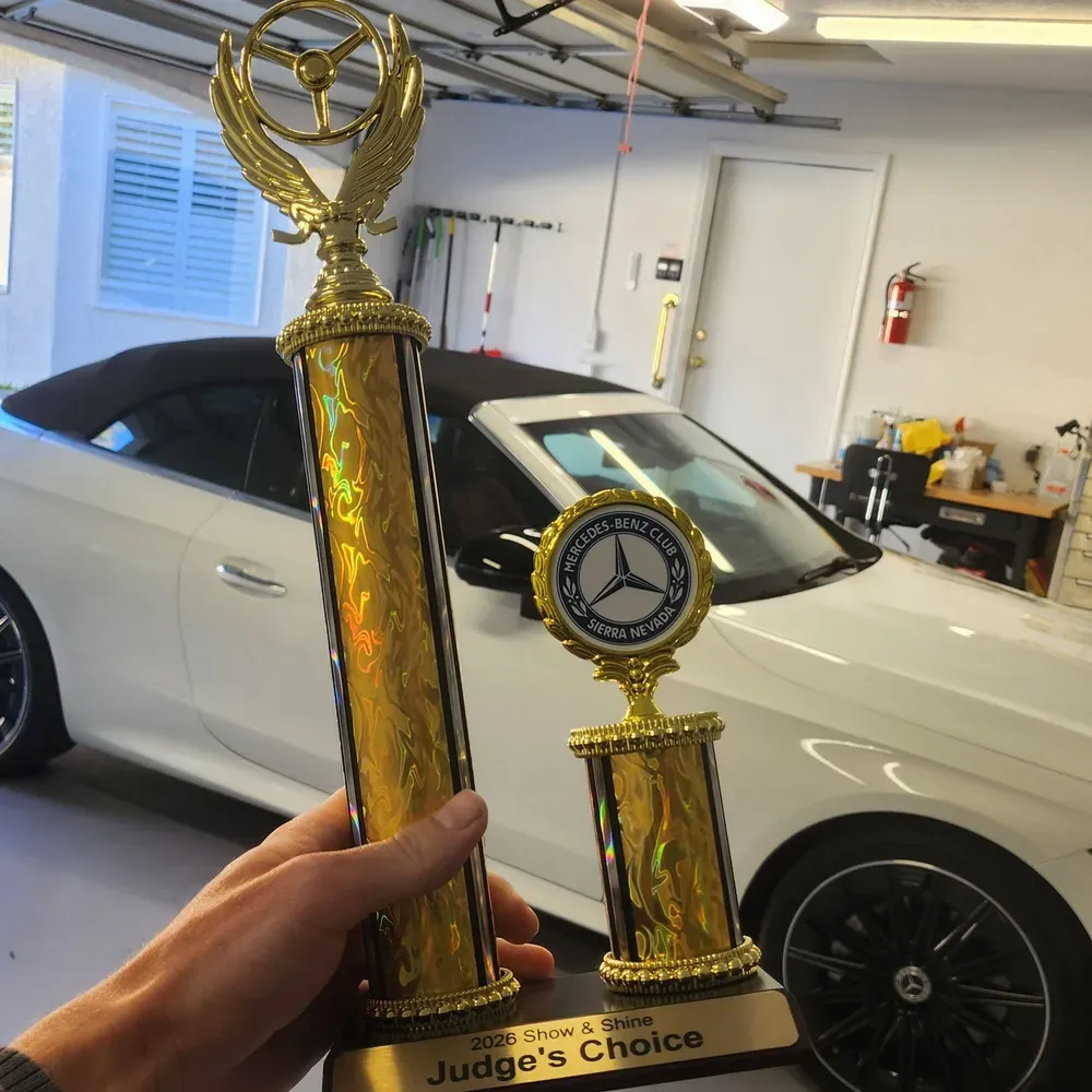 Mercedes-Benz Club Sierra Nevada Judge's Choice trophy with a ceramic coated white Mercedes-Benz CLE 450 in Reno, NV