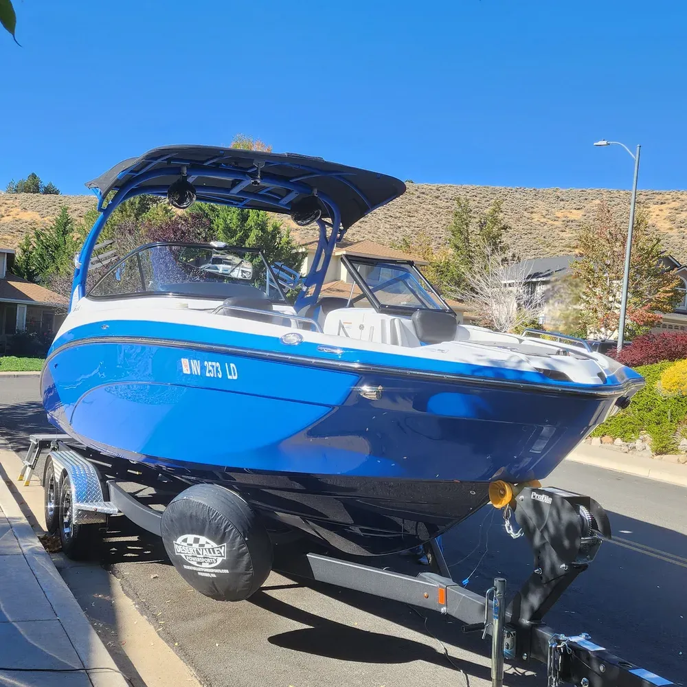 Blue Yamaha wake boat on its trailer after a compound, polish, and sealant on the gelcoat hull in Reno, NV